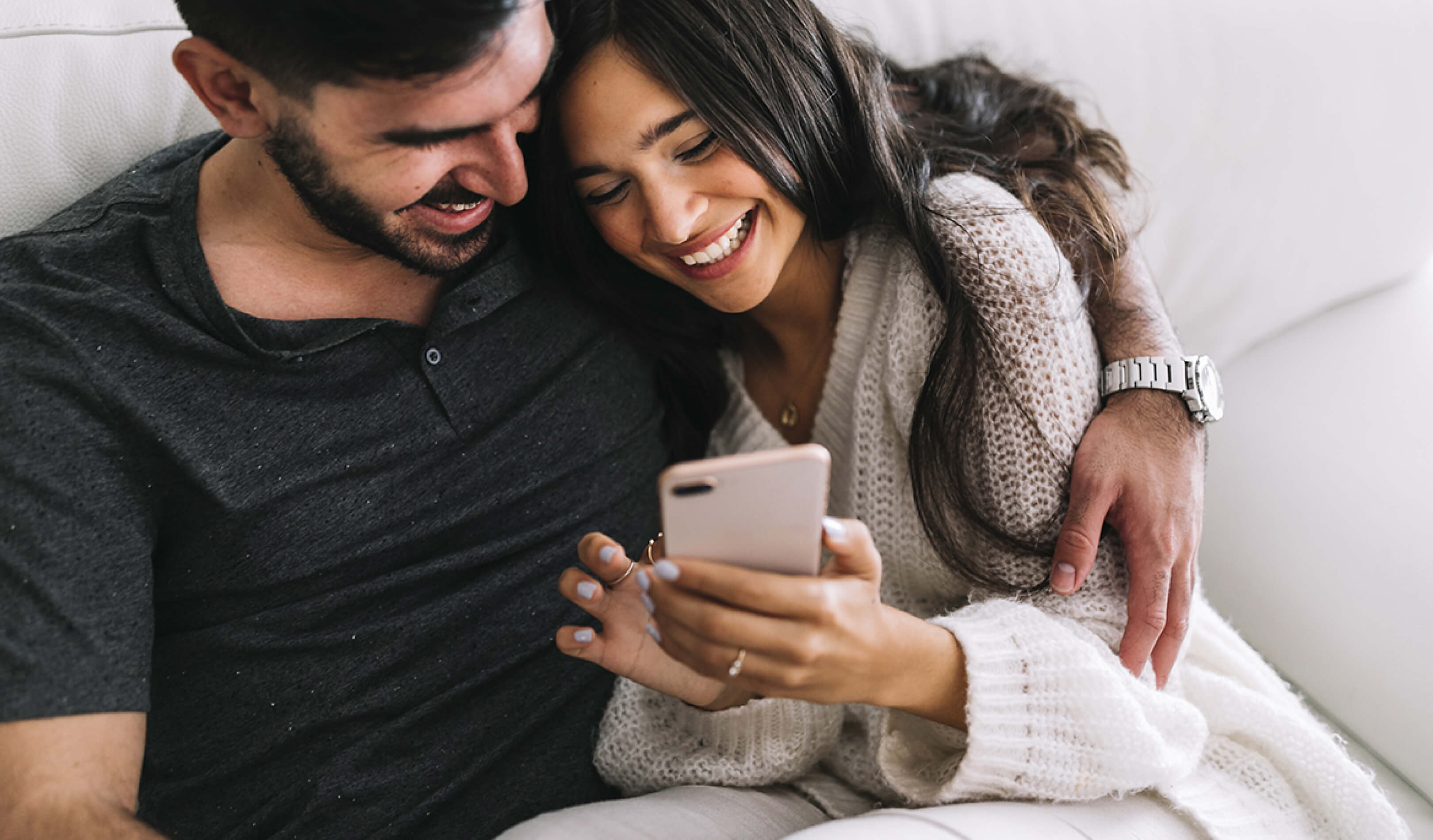 Two happy people looking at a phone